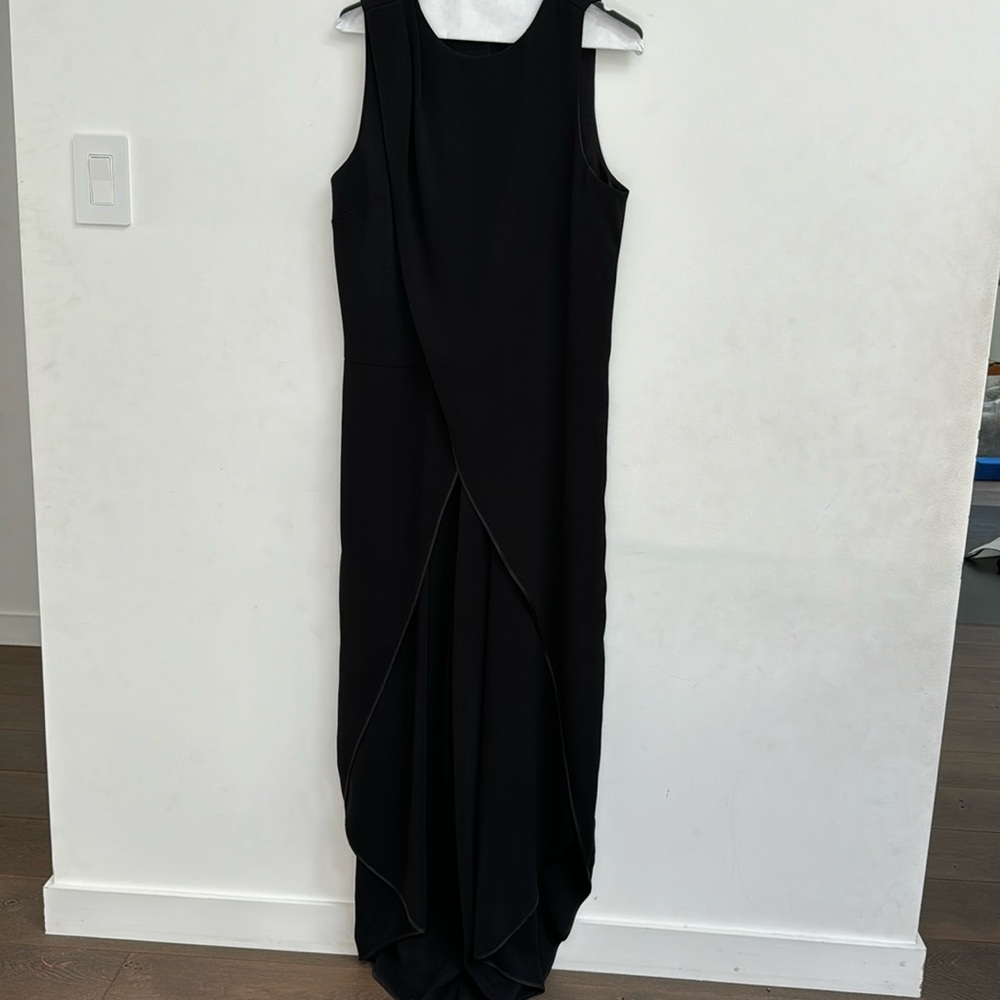 Black wide leg jumpsuit with draping in front. Flattering. Sleeveless